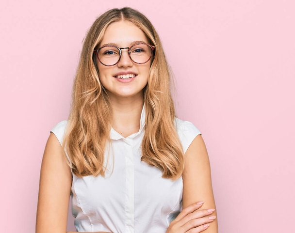 Beautiful young caucasian girl wearing casual clothes and glasses happy face smiling with crossed arms looking at the camera. positive person.  - Photo, image