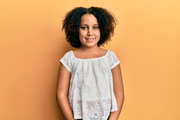 Young little girl with afro hair wearing casual clothes with a happy and cool smile on face. lucky person.  - Fotoğraf, Görsel