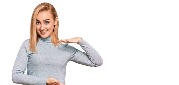 Beautiful caucasian woman wearing casual clothes gesturing with hands showing big and large size sign, measure symbol. smiling looking at the camera. measuring concept.  - Foto, immagini