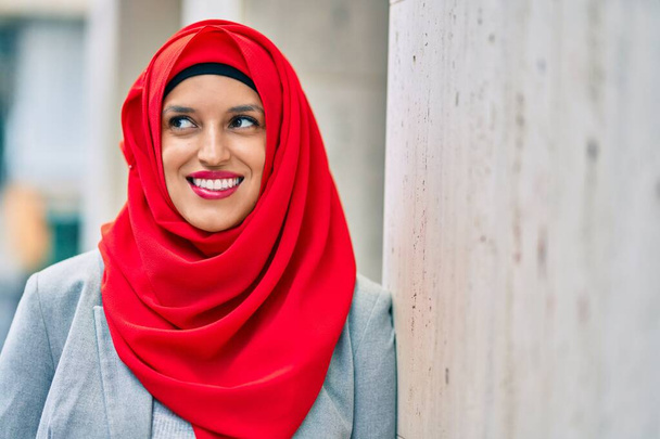 Junge Araberin im Hijab lächelt glücklich in die Stadt. - Foto, Bild