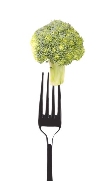 Fresh broccoli on a fork - Foto, afbeelding