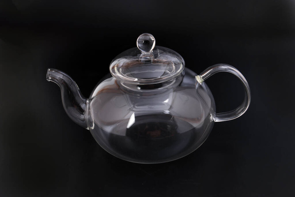 Empty transparent glass see through teapot kettle on black background - Photo, Image