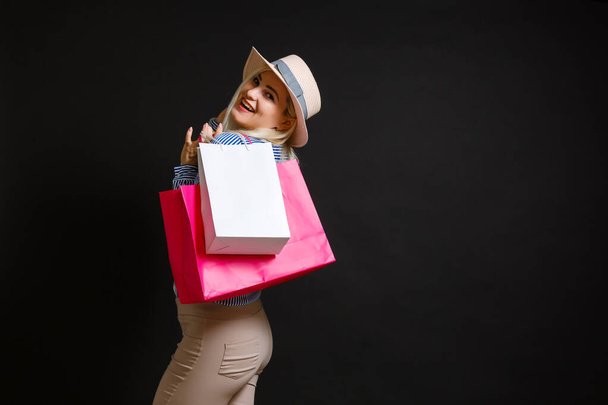 Elegant woman holding shopping bags, black friday concept - Фото, изображение
