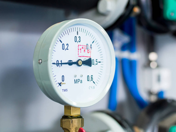 Close up of pressure meter, manometer, pipe, flow meter and faucet valves of heating system in a boiler room - Photo, Image