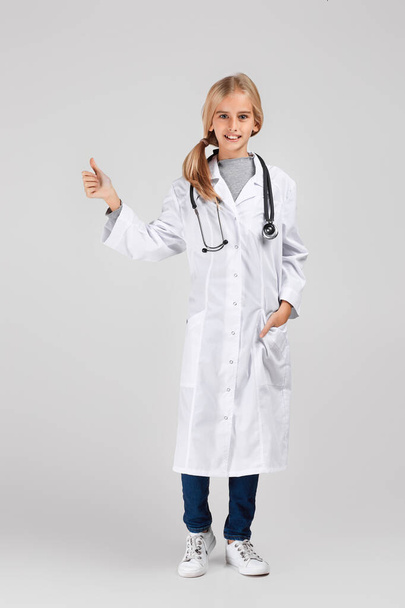 Cute child in doctor coat with stethoscope - Фото, изображение