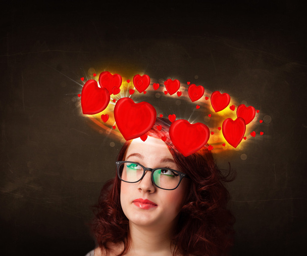teenager girl with heart illustrations circleing around her head - Foto, Bild