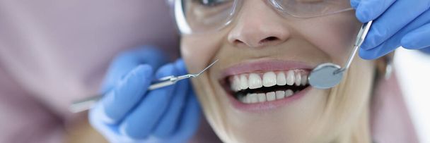 Portrait of woman with her mouth wide open at dentist appointment - Fotoğraf, Görsel