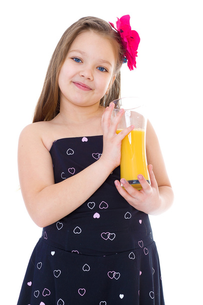 Young girl with glass of orange juice. - 写真・画像