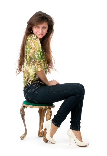 Portrait of a young woman sitting on a chair - Фото, изображение