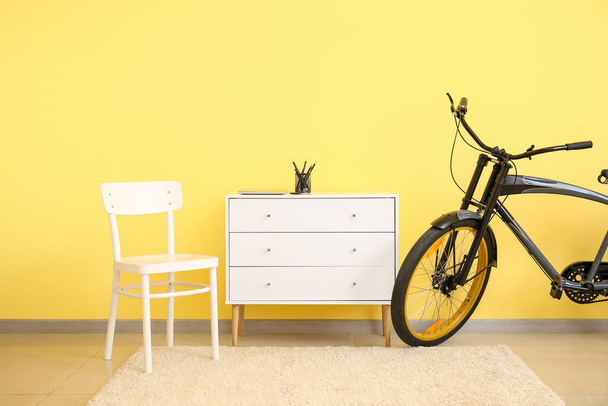 Interior of modern room with bicycle and chest of drawers - Photo, Image