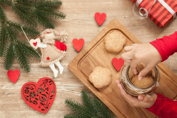 Christmas and New Year background with ingredients for cooking christmas baking decorated with fir tree. New Year's decor, homemade cookies and children's hands preparing for the holiday. - Photo, Image