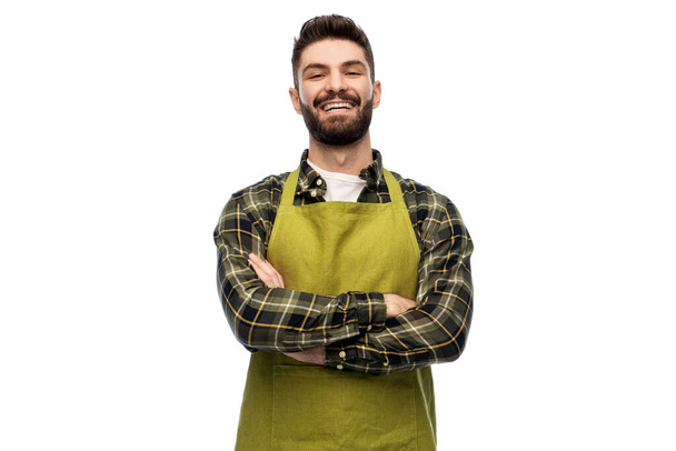 happy young male gardener or farmer in apron - Photo, image