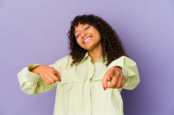 Young african american afro woman isolated cheerful smiles pointing to front. - Photo, image