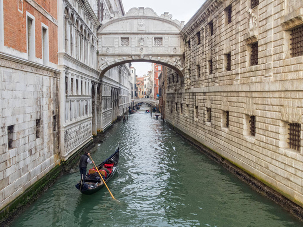 A gondola approaches the Bridge of Sighs on the Rio del Palazzo - Venice, Veneto, Italy - Photo, Image