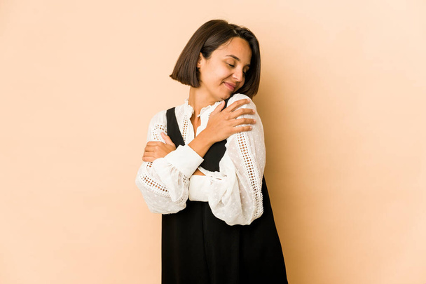 Young hispanic woman isolated hugs, smiling carefree and happy. - Fotografie, Obrázek