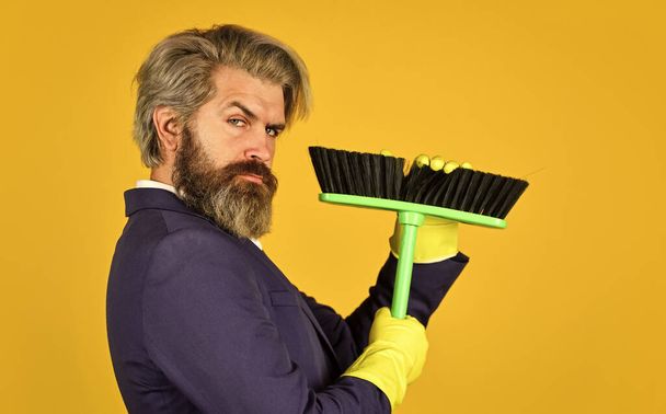 On guard of order. Cleaning day. Sweep in office. Hipster enjoy cleanliness. Cleaning business. Household duties. Cleaning service concept. Clear reputation. Bearded man formal suit hold broom brush - Photo, Image