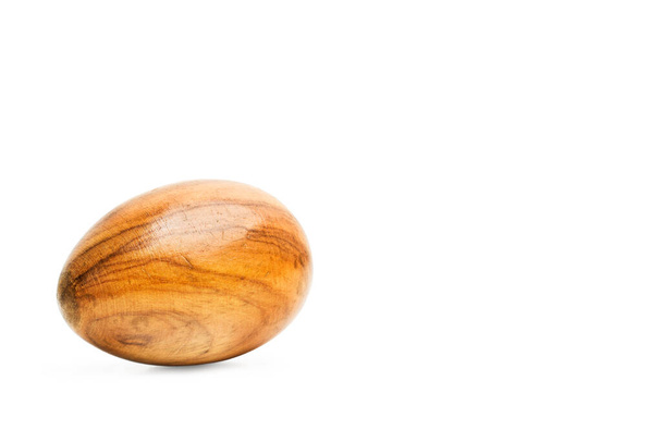 A wooden egg on a white background with copy space - Photo, Image