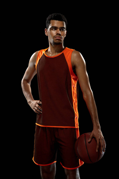 Young african basketball player training on black studio background. - Photo, Image