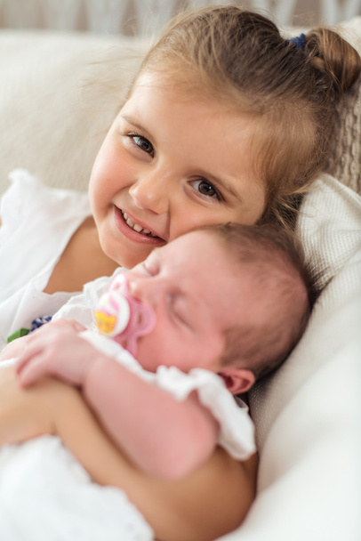 Girl holding her newborn sibbling - Fotografie, Obrázek
