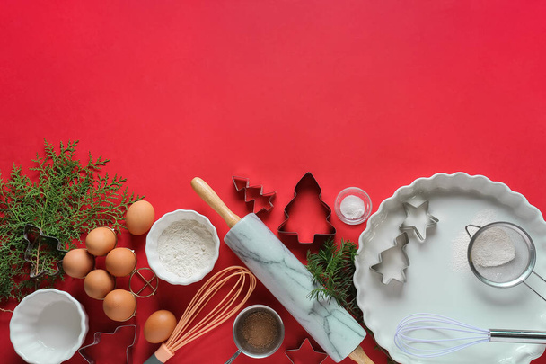 Ingredients for Christmas bakery and kitchen utensils on color background - Photo, Image