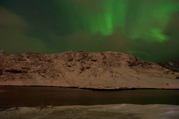 Aurora borealis Green northern lights above mountains - Valokuva, kuva