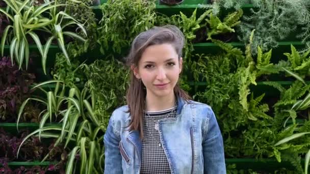 Portrait of a young brunette girl in a denim jacket - Footage, Video