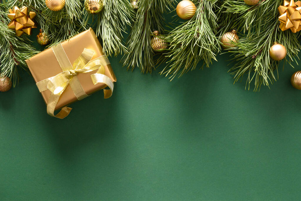 Christmas border of golden gift and balls on green. - Fotó, kép