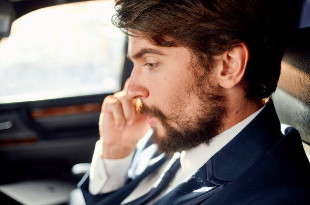 happy man talking on the phone in car portrait close-up suit - Photo, Image