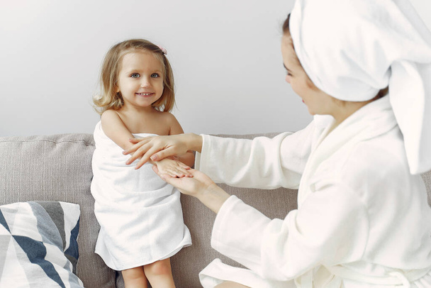 Mother with daughter in bathrobe and towels - Foto, Imagem