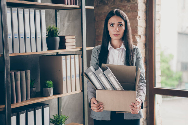 Photo of shocked frustrated girl lawyer representative lose her job dont know how live coronavirus crisis hold cardboard box wear blazer jacket suit in workplace workstation - 写真・画像
