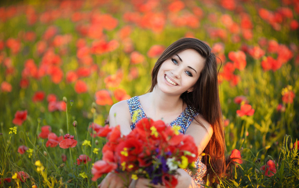 Charming girl in the poppy field. - Valokuva, kuva