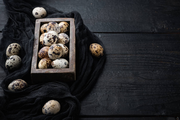 Organic quails eggs, on black wooden background  with space for text - Photo, Image