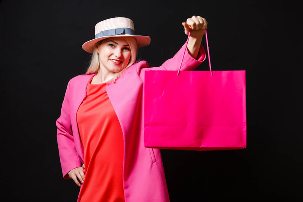 Elegant woman holding black shopping bags, black friday concept - Fotografie, Obrázek