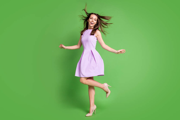 Full length body size view of her she nice-looking attractive pretty charming fashionable glad cheerful cheery girl having fun enjoying holiday free time dancing isolated over green color background - Photo, Image