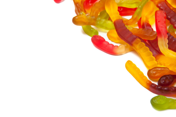 Tasty jelly worms isolated on white background. Colorful sweet gummy worms. With place for text. - 写真・画像
