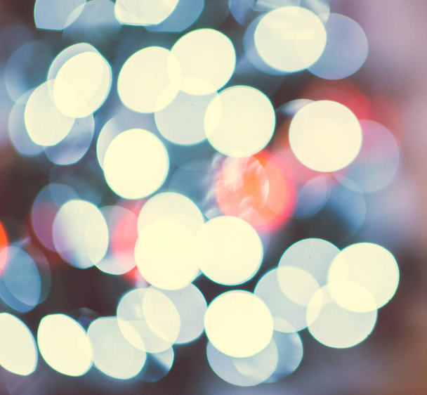 Photo of defocused colorful bokeh lights on christmas tree at new years tree - 写真・画像