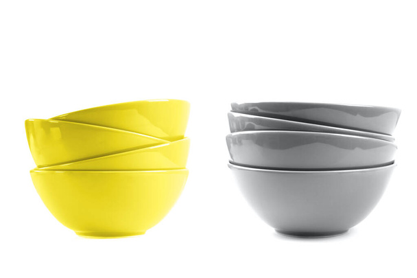 Two stacks of bowls yellow and gray color isolated on white. - Photo, Image