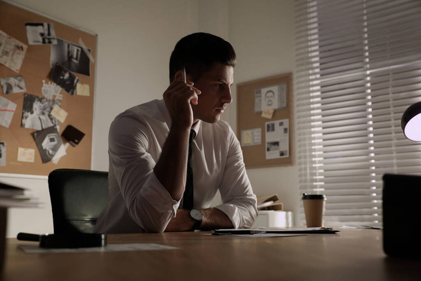 Detective working at desk in his office - Foto, Imagem