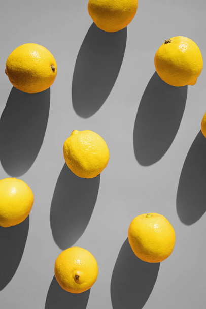 Flat lay composition with lemons on grey background - Фото, изображение