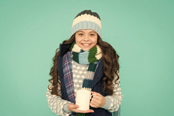 Have warming drink. more ideas for warming. winter vibes. happy girl hipster. kid winter fashion. feeling good any weather. Stay active this season. kid warm knitwear. child hot tea cup - Zdjęcie, obraz