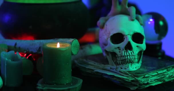 Boszorkány emberi koponya, gyertya és grimoire, közelkép - Felvétel, videó