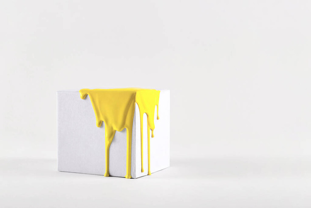 White cube with smudges of bright yellow paint color of the year 2021 - Photo, Image