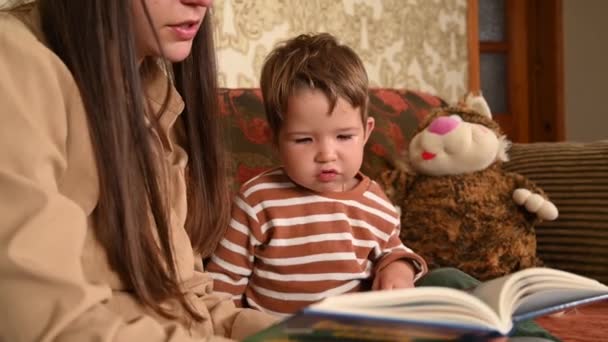 mom and child read a book before bedtime child Child's education at home - Footage, Video