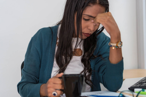 Young woman working in the office with a headache - Photo, Image