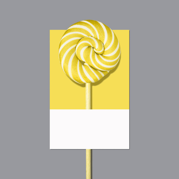 Vířivka Osvětlující žluté lízátko cukroví na Ultimate Gray barevné paletě. - Fotografie, Obrázek