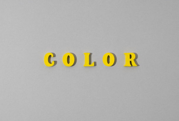 Abstract paper gray background with yellow wooden word. - Foto, immagini