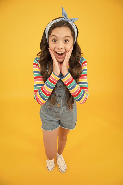 surprised little girl wear retro headscarf. summer kid fashion. be positive and stylish this spring. female accessory for trendy look. childhood happiness. child has long curly hair - 写真・画像