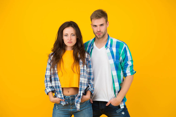 Their style is a lot more casual. Couple in casual wear. Vogue models yellow background. Fashion clothes. Contemporary streetwear. Trendy lifestyle. Dont miss our latest trends in clothing - Valokuva, kuva