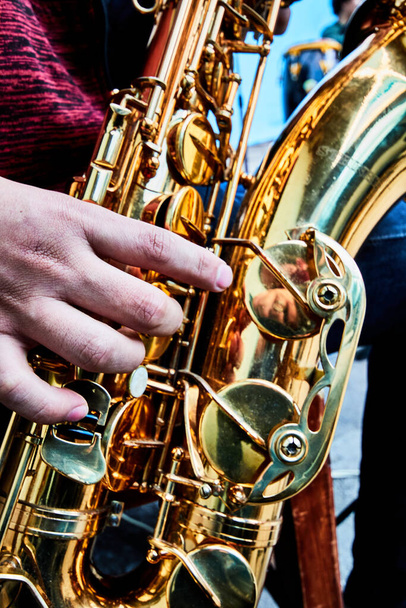 hand and saxophone details in a band, music show - 写真・画像