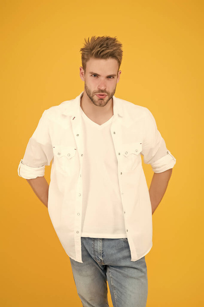 Casually handsome. Casual urban lifestyle. businessman in jeans and shirt. portrait of millennial man in casual clothes. Handsome man wear white tshirt and posing in studio - Photo, Image
